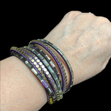 Leather and silver wrap bracelet. Goldtone snaps, purple leather.