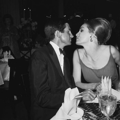 American actors George Hamilton Julie Newmar kissing at a party fo- Old Photo