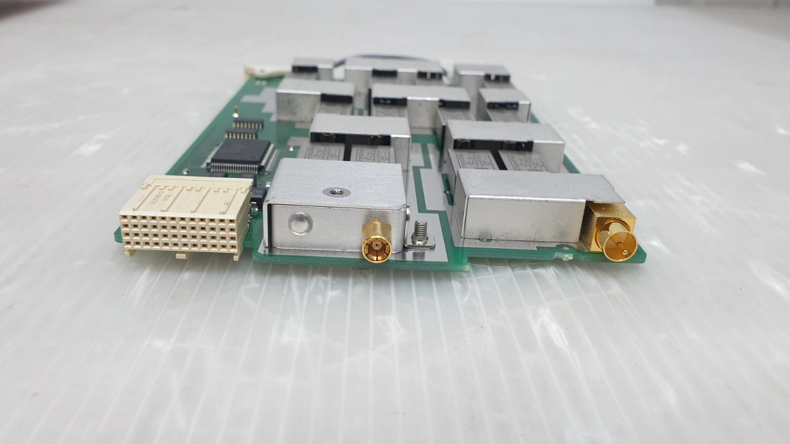 Edge view of the E3120-66512 board: backplane connector and coax ports