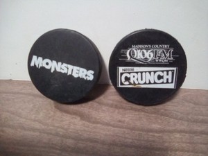 2 Monsters Hockey Puck Lot Nestle Crunch Logo Madison WI 106 FM Logo