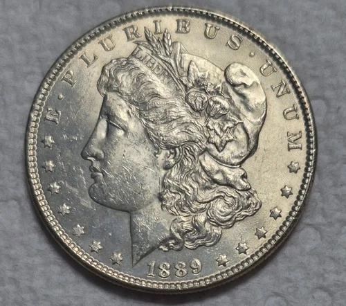 1889 P Morgan Silver Dollar. Estimated  Uncirculated 63. Golden Toning  A0297