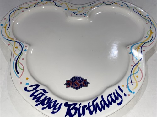 White plate with colorful Mickey Mouse outline, “Happy Birthday!” text, and USA map design on a patterned background.