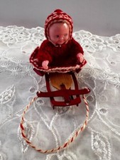 Vintage Celluloid Baby Red White Knit Winter Wear on Sled Super Cute Movable