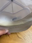 White vintage trucker hat with yellow brim, green lining, and small blue label reading “Graham’s Screen Printing.”