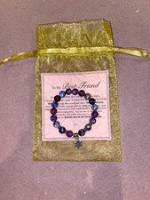 Womans stretch bracelet with 10mm natural stone beads and flower charm.