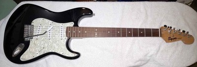 Squier Strat by Fender Electric Guitar Good Condition ProSetup Soft Case.