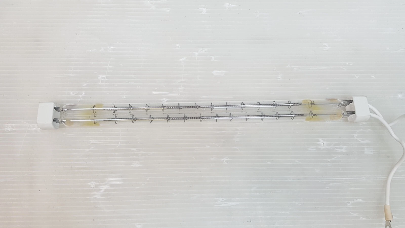 Twin quartz tubes with coiled tungsten filaments and ring supports