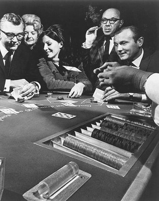 Blackjack players risk some cash at a Las Vegas casino Old Photo