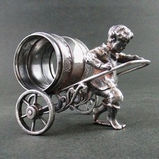BOY Pulling a WHEELED CART (leaf) - antique Figural Napkin Ring - WILCOX #01577