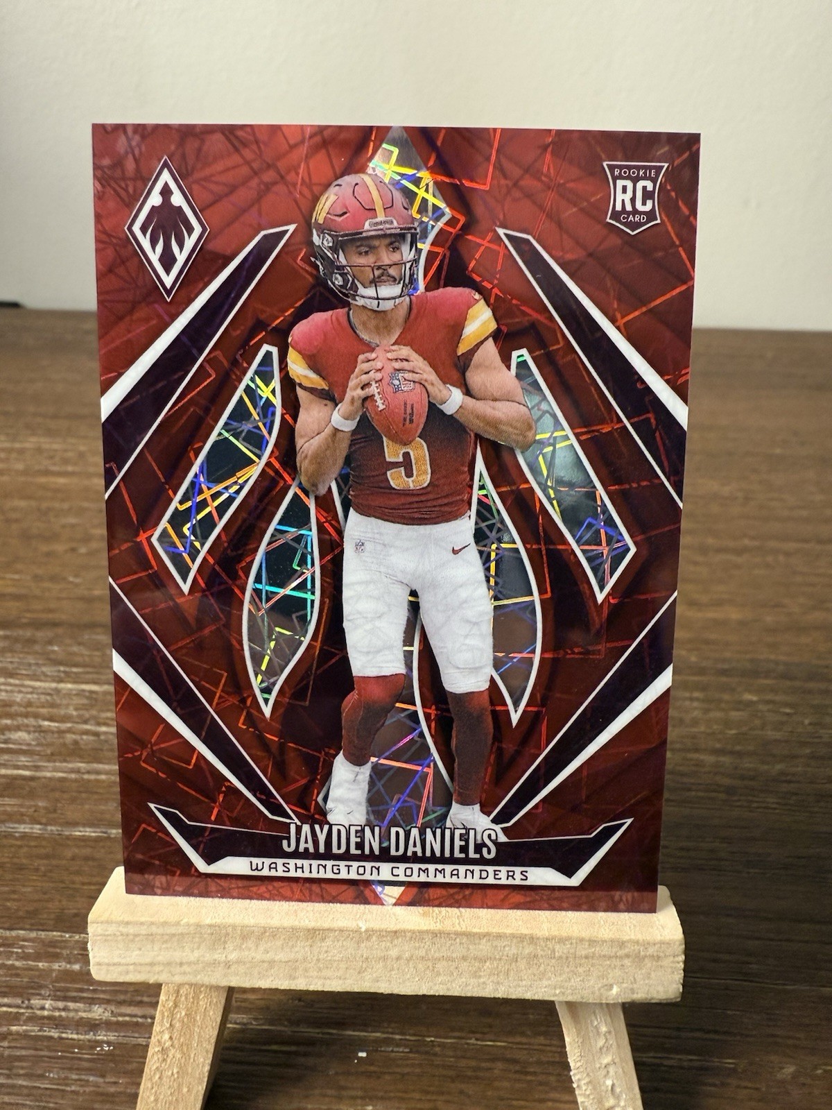 2024 Panini Phoenix - Rookies Jayden Daniels #198 Red Lazer /199 (RC)