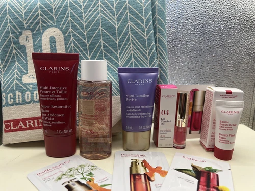 Clarins Travel Set FEED 9PC Set-NUTRI LUMIERE DAY/MICELLAR WATER/LIP OIL/ABDOMEN