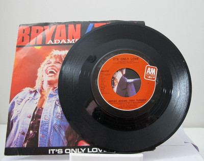 45 RECORD - BRYAN ADAMS AND TINA TURNER - IT'S ONLY LOVE