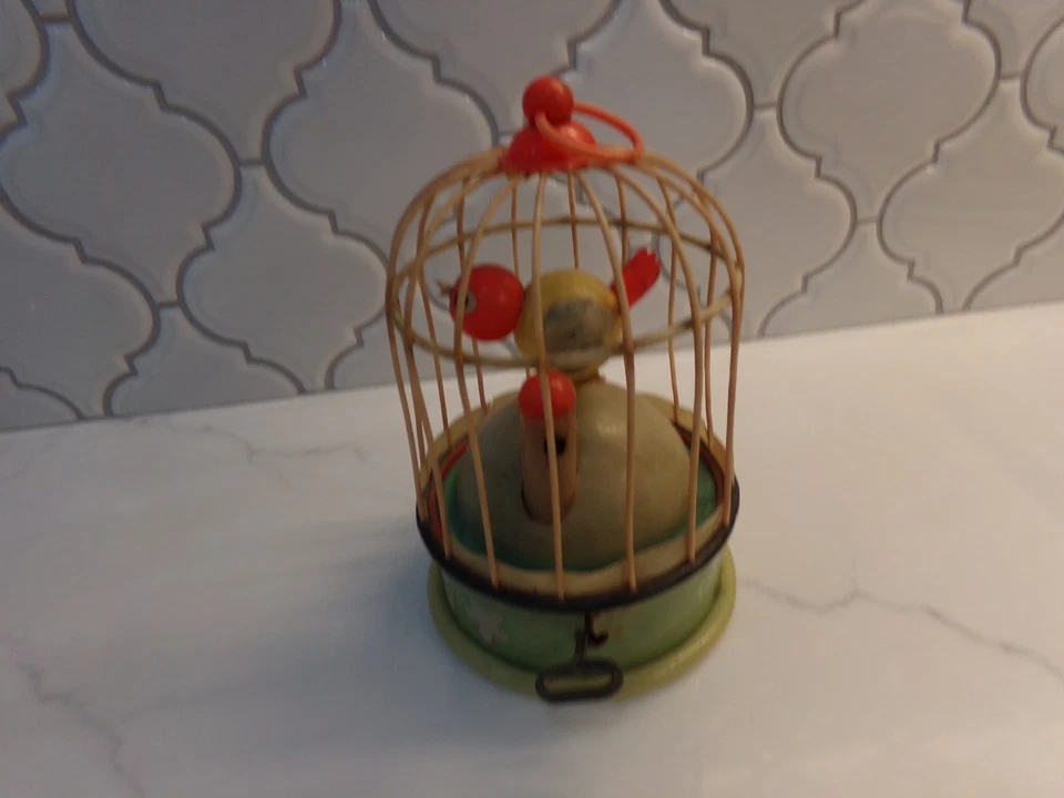 Pájaro cantando celuloide en una jaula sin marca Foto 2 de 4