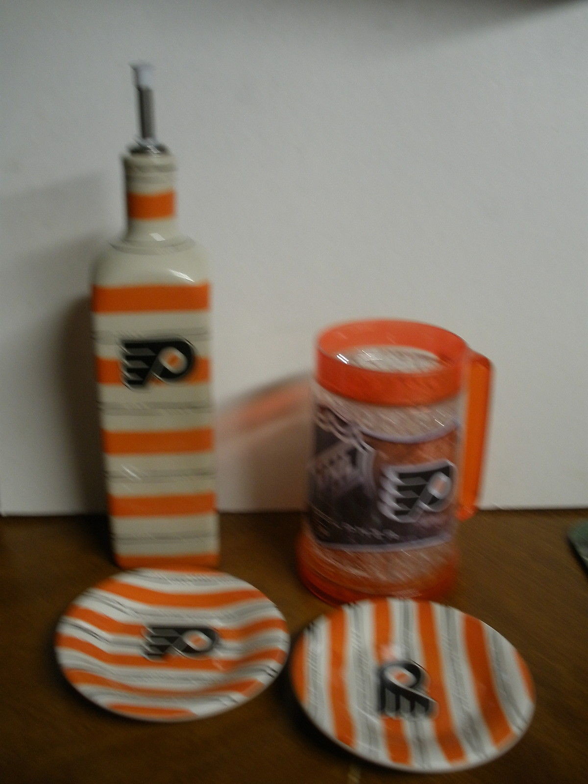 lot of Philadelphia Flyers kitchen items plates, tall bottle, frosted mug