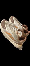 Adidas Ozelia sneaker in a beige/brown/orange colorway. Kid 13k