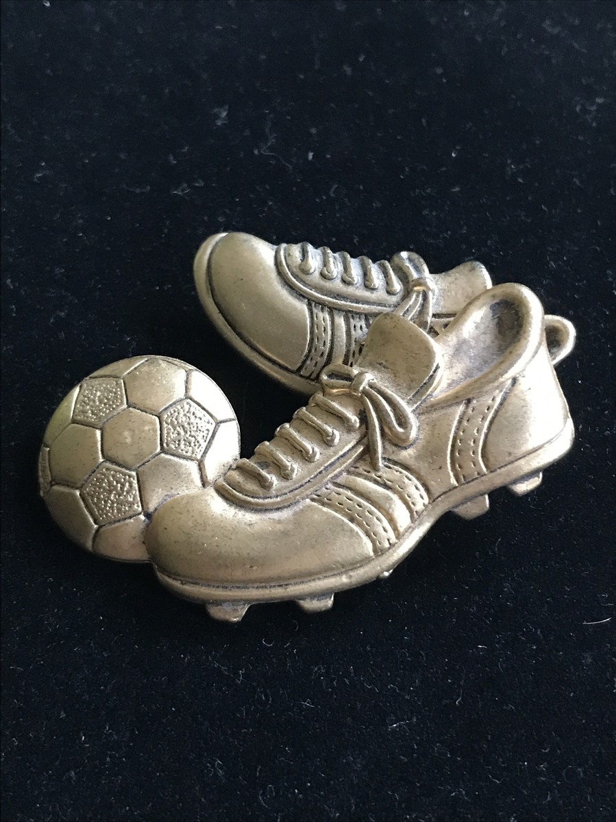 Gold tone Articulated cleats shoes kicking a soccer ball sports