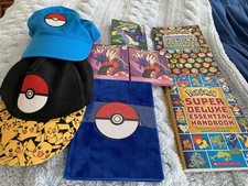 Pok mon Bundle- 8 pieces Handbooks, Caps, Sticker Sheets