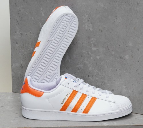 orange and white shell toe adidas