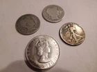 3 silver half dollars and 1 Bermuda crown