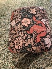 Small pink upholstered footstool with William Morris Compton removable cover