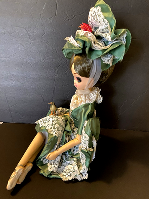 Vintage Big Eyes Bradley Doll Seated With Spun Cotton Bird Green