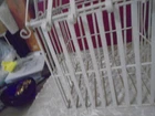 White metal bird cage with hook for hanging. Opens at the top. Front clasp