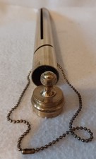 VINTAGE BRASS CYLINDRICAL £1 COIN SAVINGS BANK WITH LID AND ATTACHED CHAIN