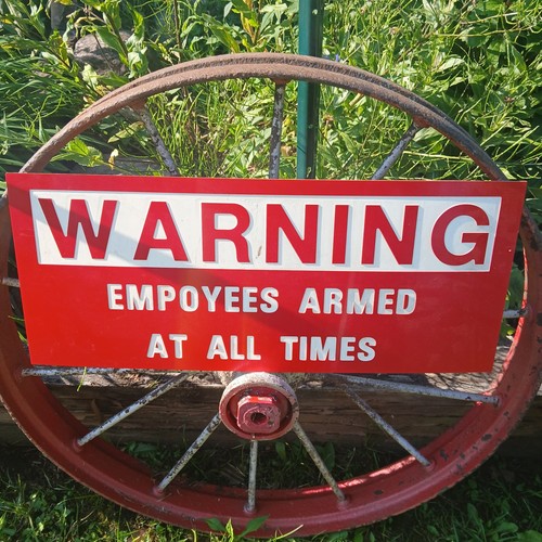Gun shop "Warning Employees armed at all times" sign.