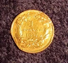 Photo of a 1857-P Gold Dollar from an eBay listing that sold on May 11, 2026