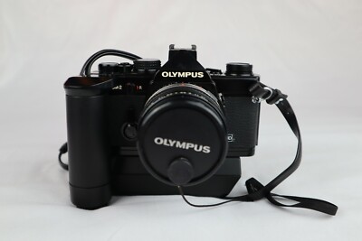 OLYMPUS OM-2 35MM SLR FILM CAMERA W/OLYMPUS 1:1.8 F=50MM LENS & VIVITAR 28MM 1:2