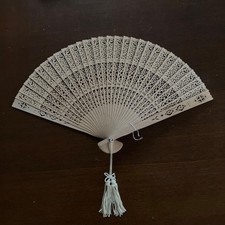 Creamcolored carved folding fan with floral gift box