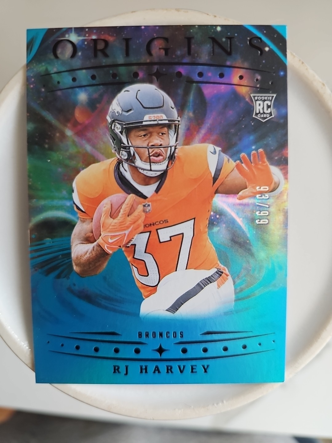2025 Panini Origins - Rookies RJ Harvey, RJ Harvey #141 Blue /99 (RC)