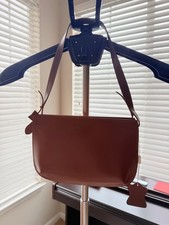 Brown shoulder bag with adjustable strap and gold-tone hardware