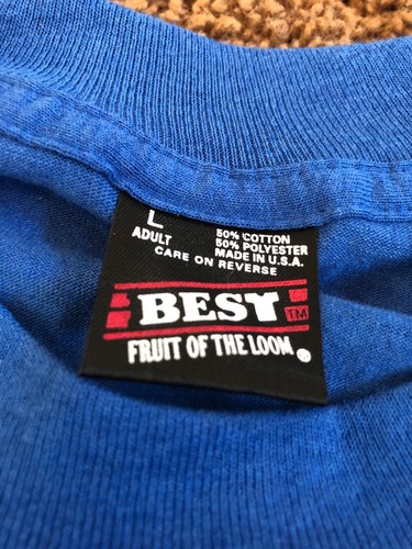 Blue short-sleeve shirt with white “EU” label, red “Fruit of the Loom” text, and USA Made stamp.