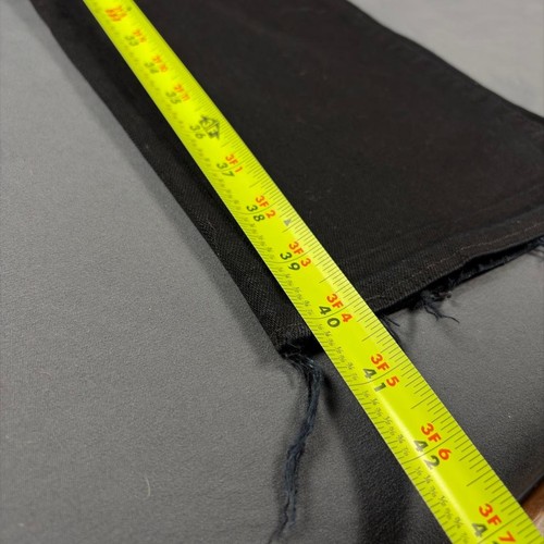 Black denim bootcut jeans with frayed hems, yellow measuring tape along the waistband, showing size 3F 4A.