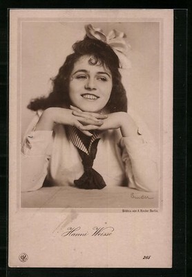 Actress Hanni Weisse rests her chin on her folded hands.