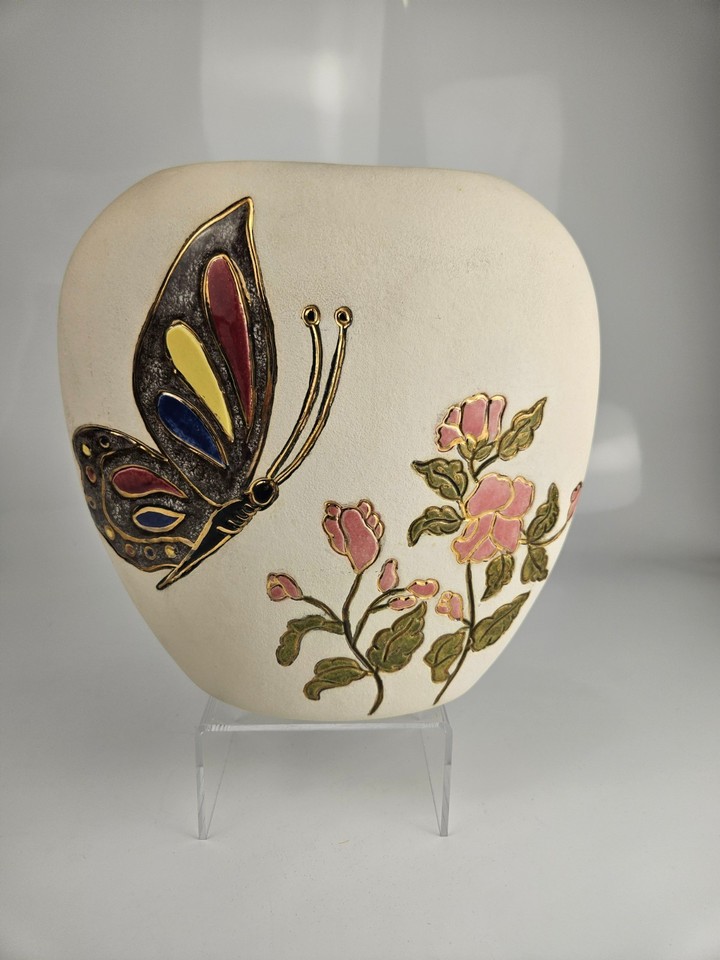Ivory MCM art pottery with raised butterfly and floral relief — sculptural, decorative, and genuinely striking on a mantle.