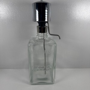vintage glass liquor pump decanter with a chrome-plated pump mechanism
