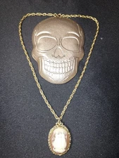 vintage Max Factor solid perfume cameo locket necklace, typically from the 1970s