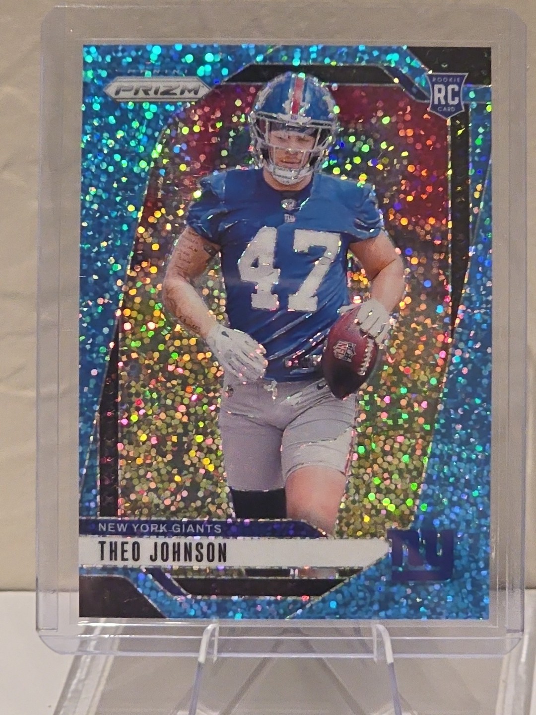 2024 Panini Prizm Rookies Theo Johnson #390 Blue Sparkle Prizm /96 (RC)