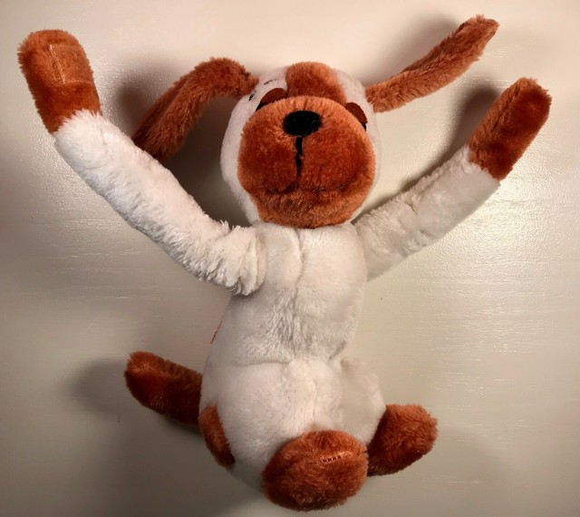 dog hugging stuffed animal
