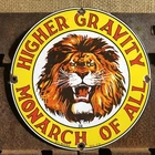 VINTAGE 1934 DATED HIGHER GRAVITY MONARCH OF ALL LION 10” PORCELAIN GAS OIL SIGN