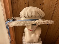The Ladies Hat Is From  1795.  The Hat Has A Wide Brim, With Pretty Flowers.