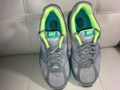 neon green and gray nike shoes