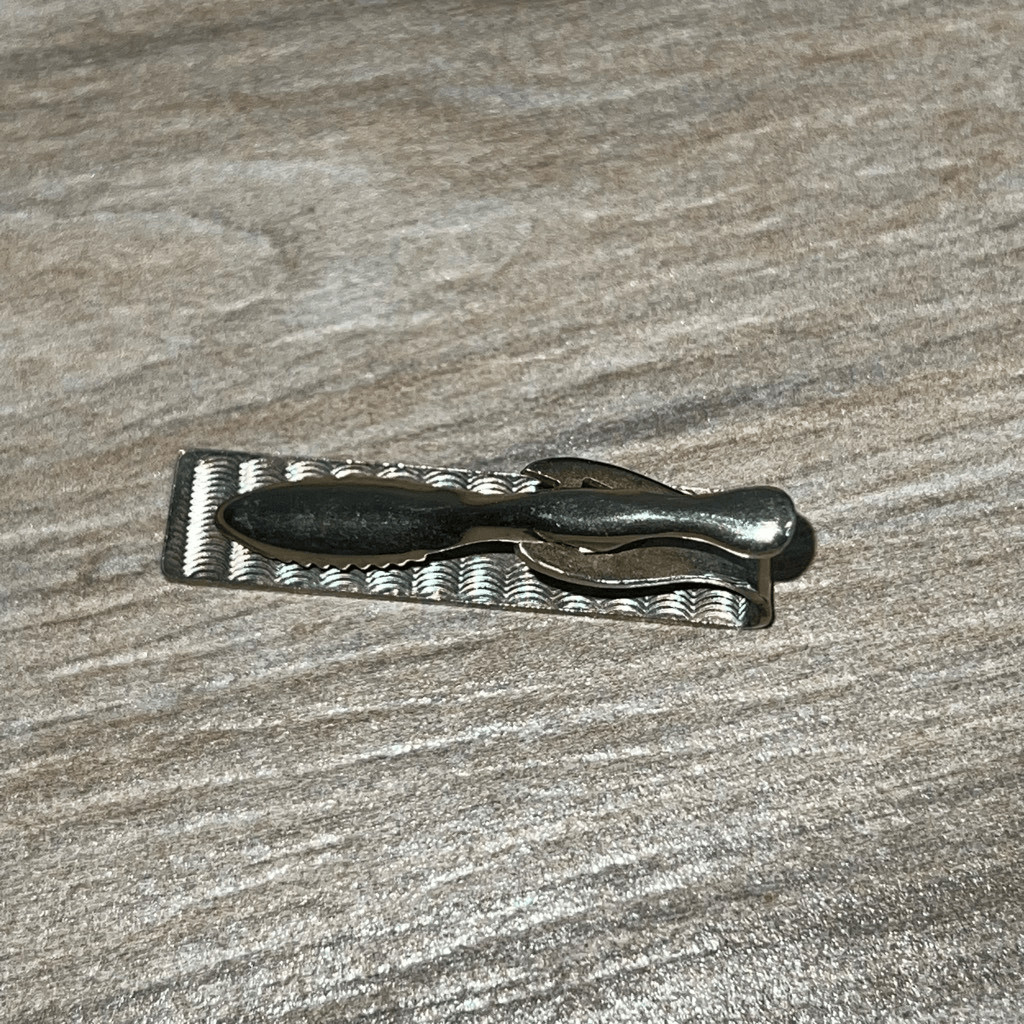 Vintage 1970s Swank BOB name tie clip with a football motif