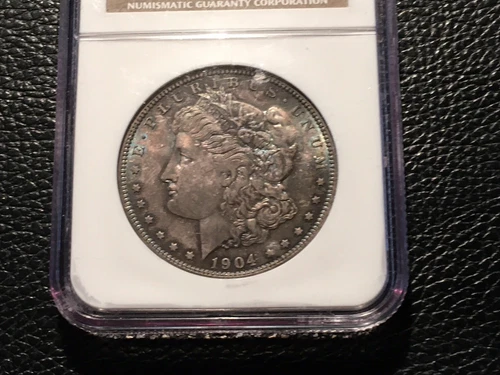 1904-O Morgan Dollar NGC 64 Unc Incredible Blue Green Color Spot On The Case Top