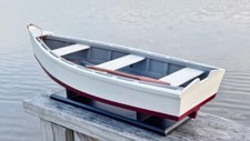 WOODEN SKIFF MODEL, 17.50 INCHES LONG, WITH ANCHOR, PADDLE AND DISPLAY STAND