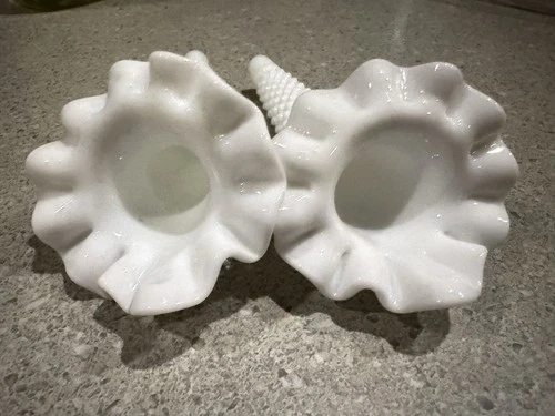 A pair of Fenton hobnail milk glass epergne horns with ruffled rims.