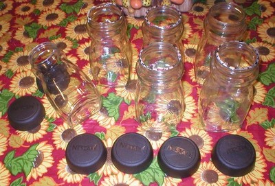 6 EMPTY NESCAFE GLASS JARS SOLD AS IS