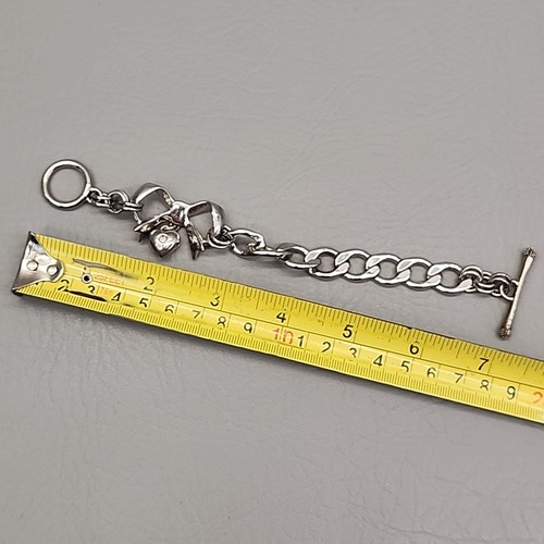Pulsera de cadena Juicy Couture arco corazón cinta colgante tono plata bordillo 7" - Imagen 10 de 11
